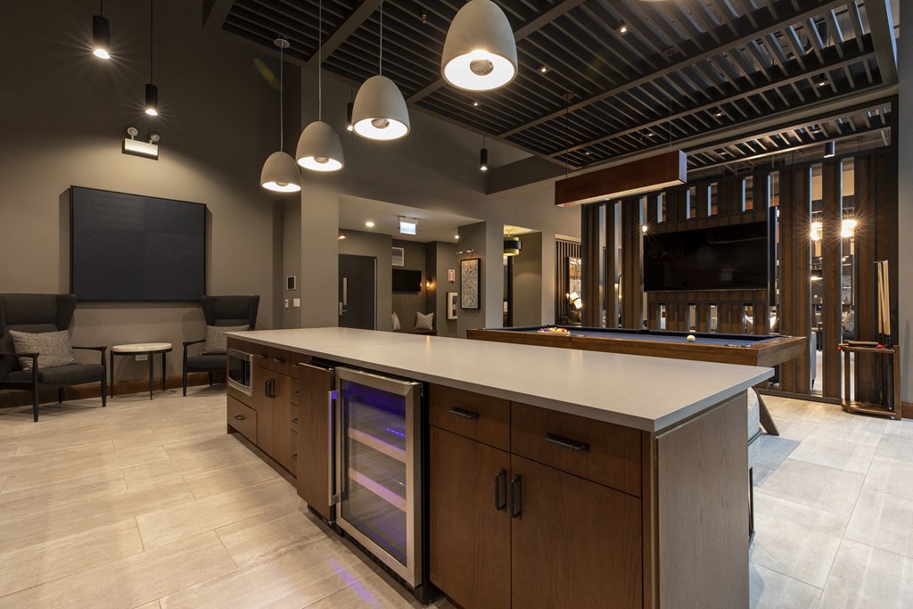 a large kitchen with a counter top and a tv in a room