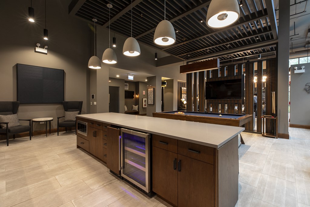 a large kitchen with a counter top and a tv in a room with other furniture
