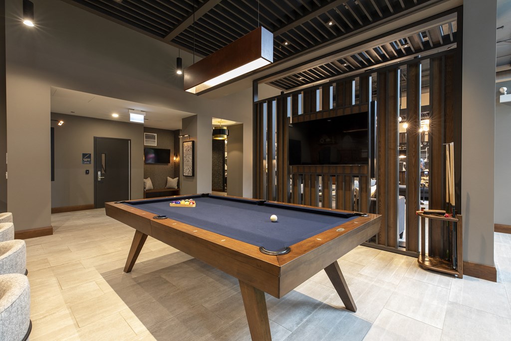 a billiards table in a living room with a tv