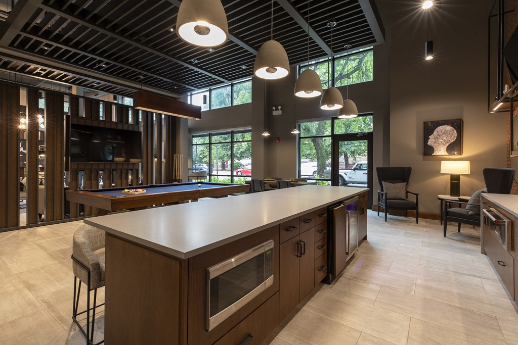 a large kitchen with a pool table and a bar