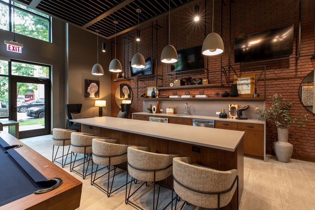 the lobby of a restaurant with a bar and chairs