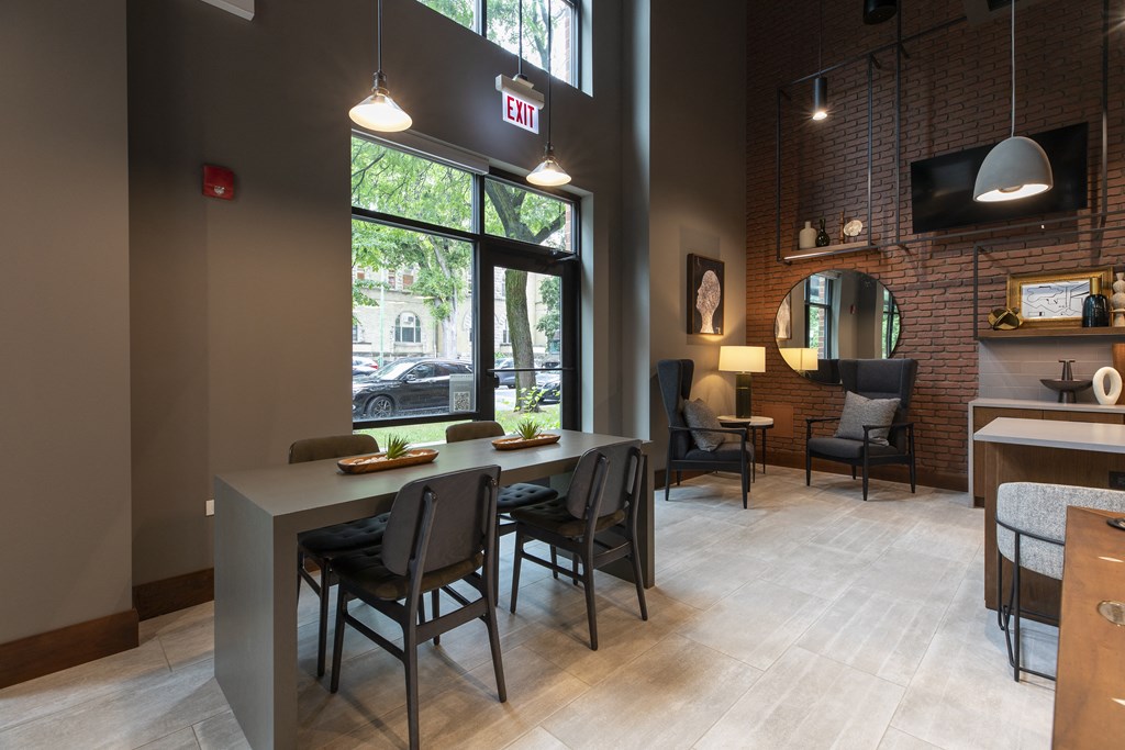a dining room with a long table and chairs and a large window