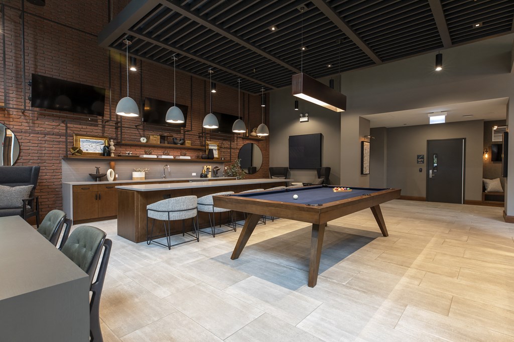 a games room with a pool table and a bar