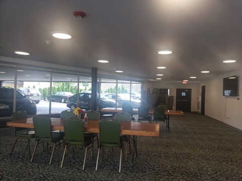 A conference room with a long table and chairs.
