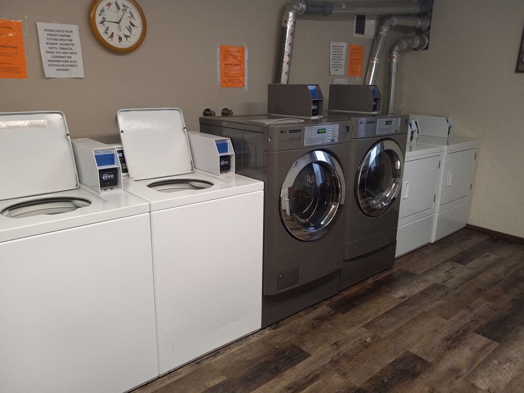 a row of washers and dryers in a laundromat