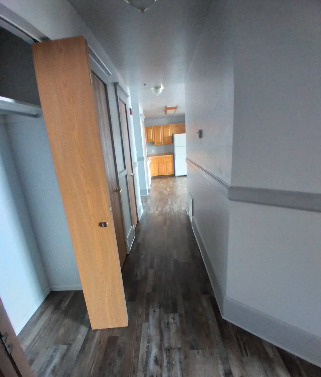 a large wooden door in the middle of a hallway in a house