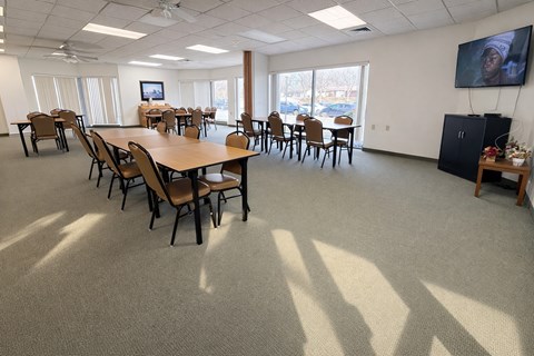 A conference room with a long table and chairs.