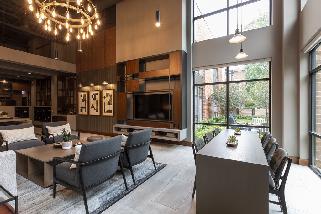 a dining room and living room with a table and chairs and a large window