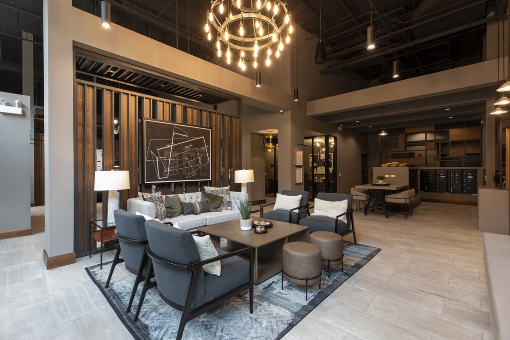 a living room with couches and chairs and a table