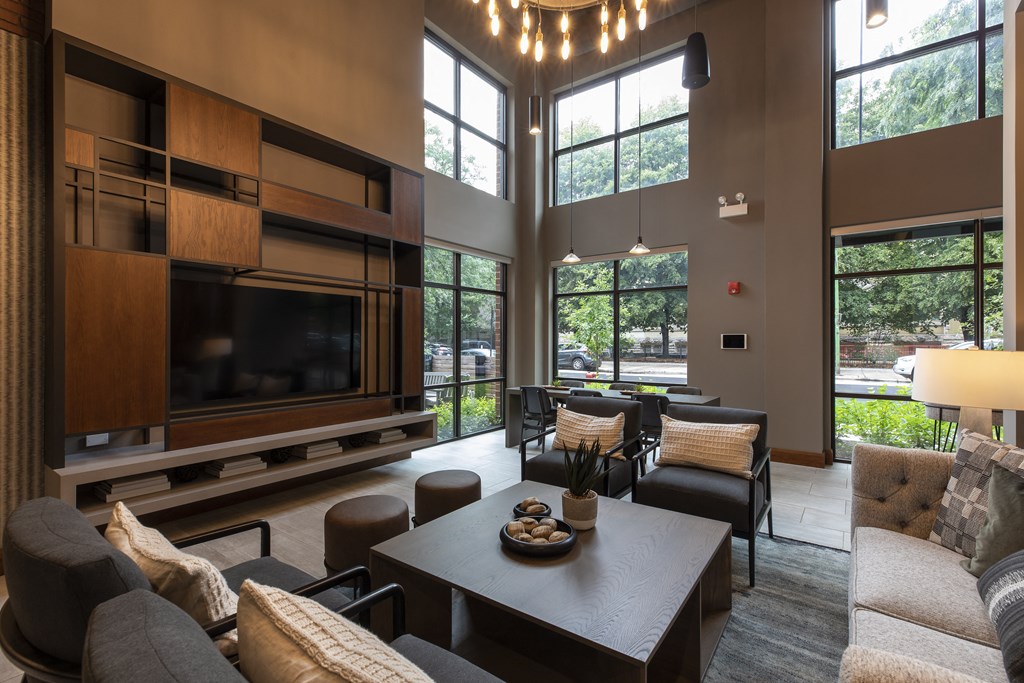 a living room with couches and a table and a television