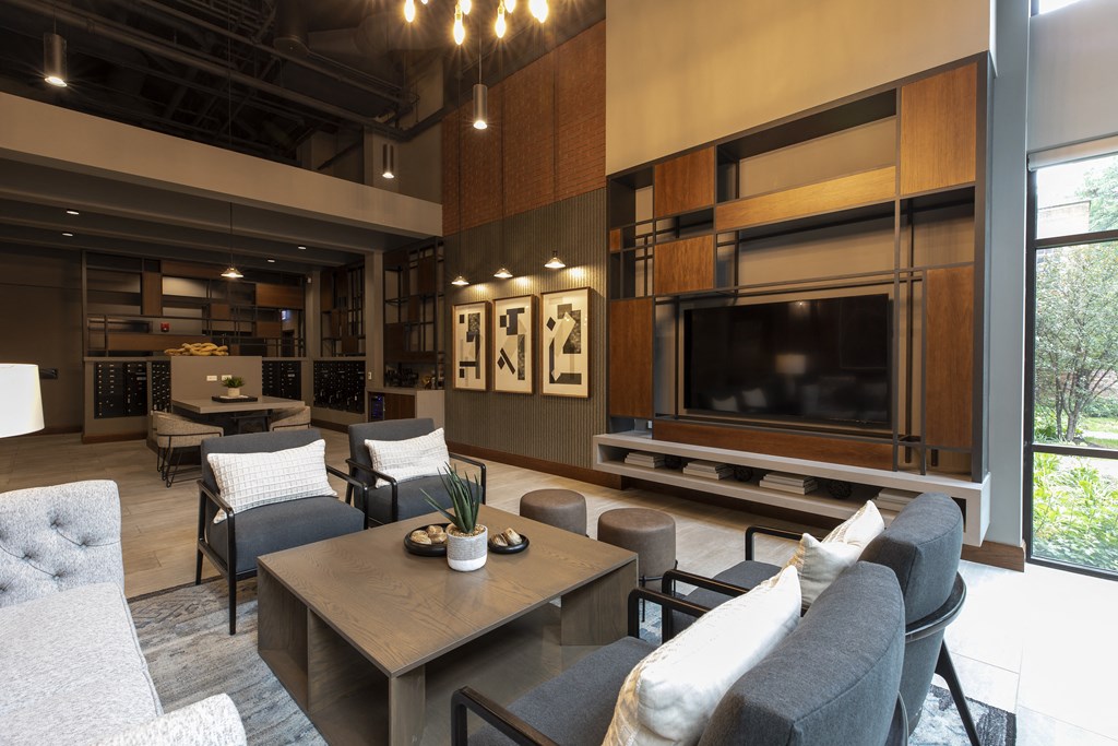 a living room with a tv and a table and chairs