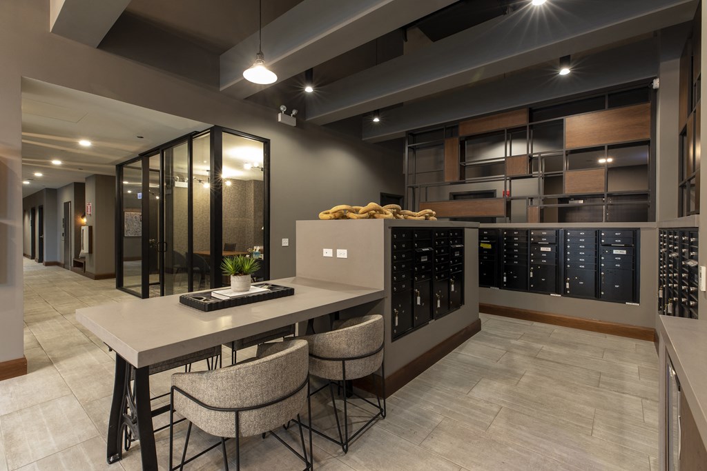 a wine tasting room with a long counter with chairs and a row of wine racks