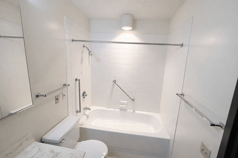 A white bathroom with a toilet, sink, and bathtub.
