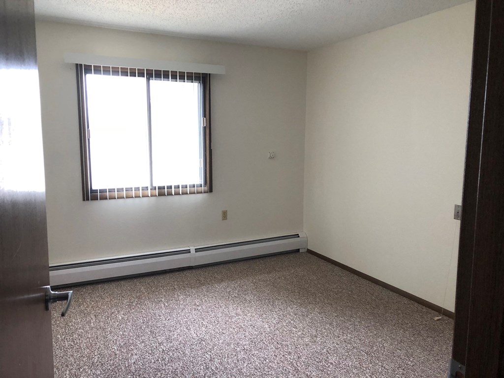 A room with a window and a door.