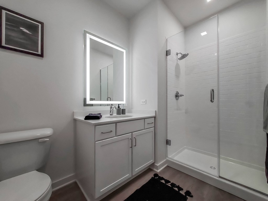 a bathroom with a shower and a sink and a mirror