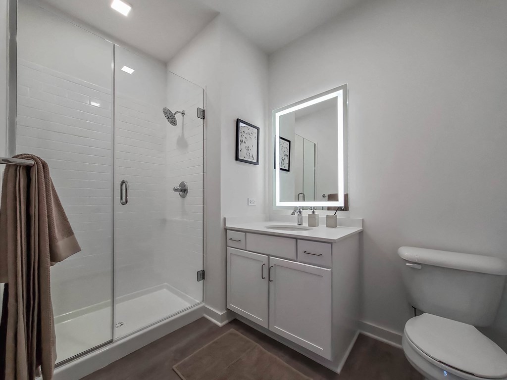 a white bathroom with a shower and a sink