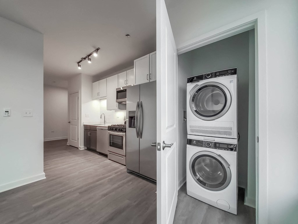 a washer and dryer in a living room with a kitchen