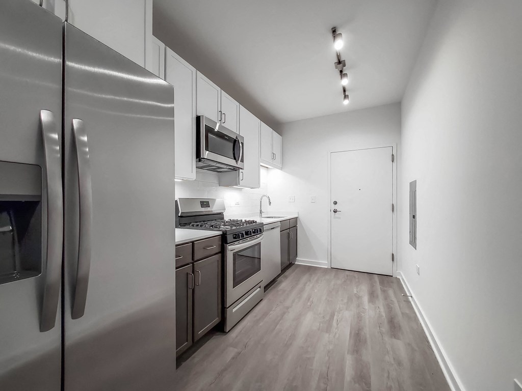 a kitchen with stainless steel appliances and white cabinets