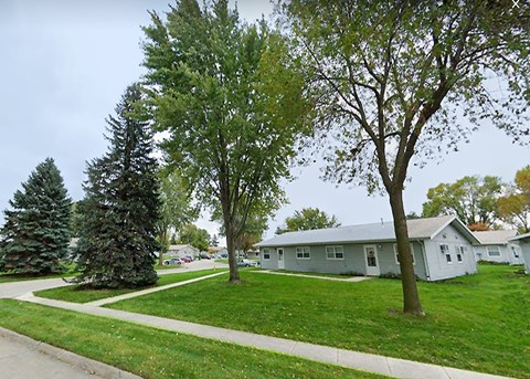 A tree in front of a house.