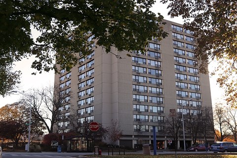 A tall building with a stop sign in front of it.