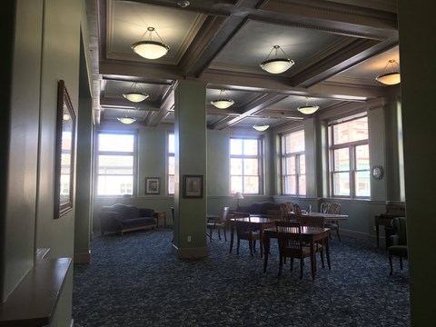a dining room in a building with tables and chairs