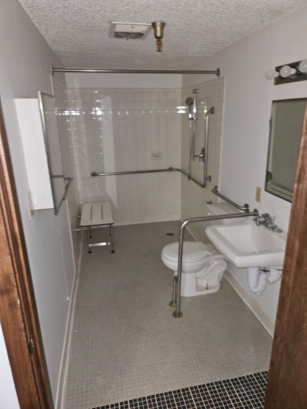 A bathroom with a sink, toilet, and shower.