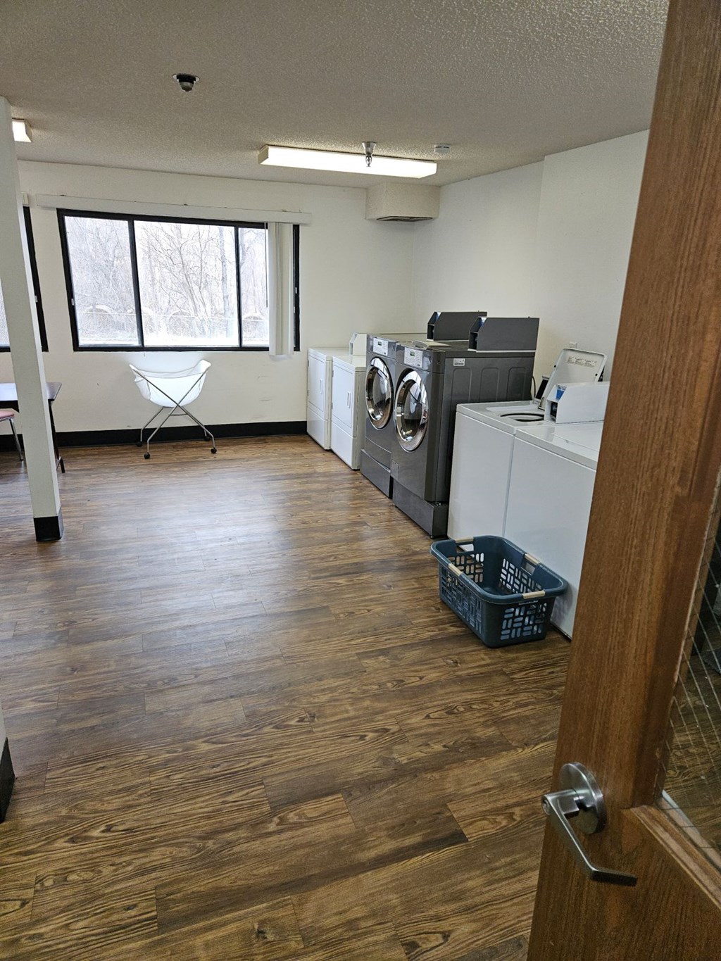 A room with a washer and dryer set up.