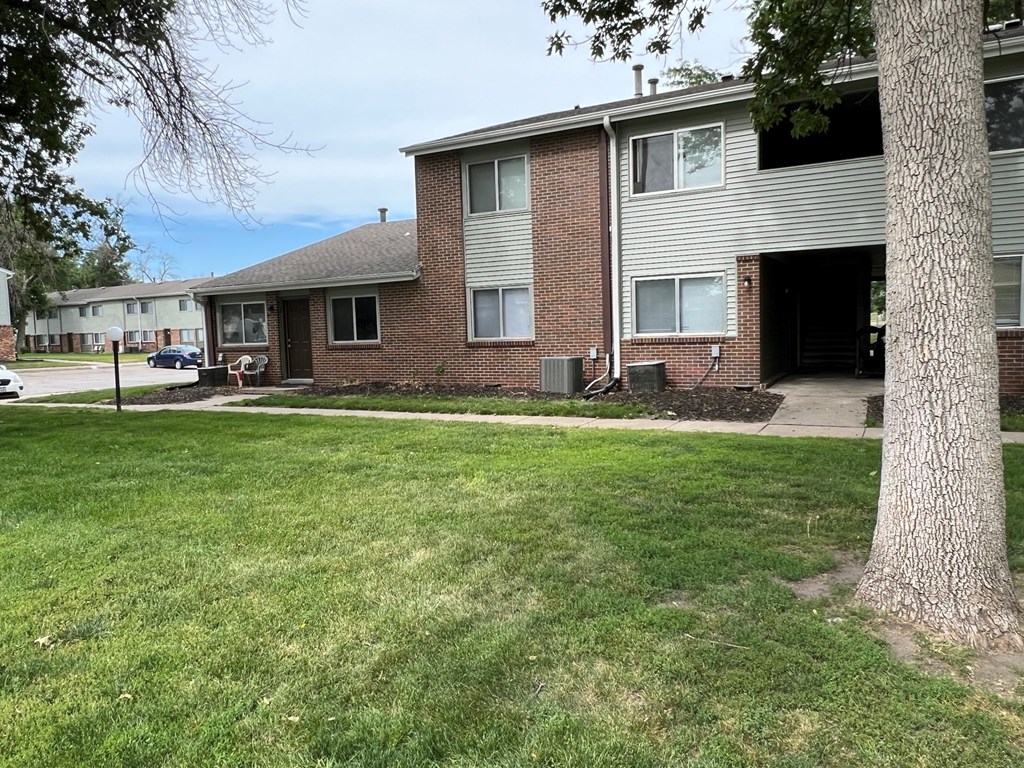 a view of the exterior of a brick apartment building