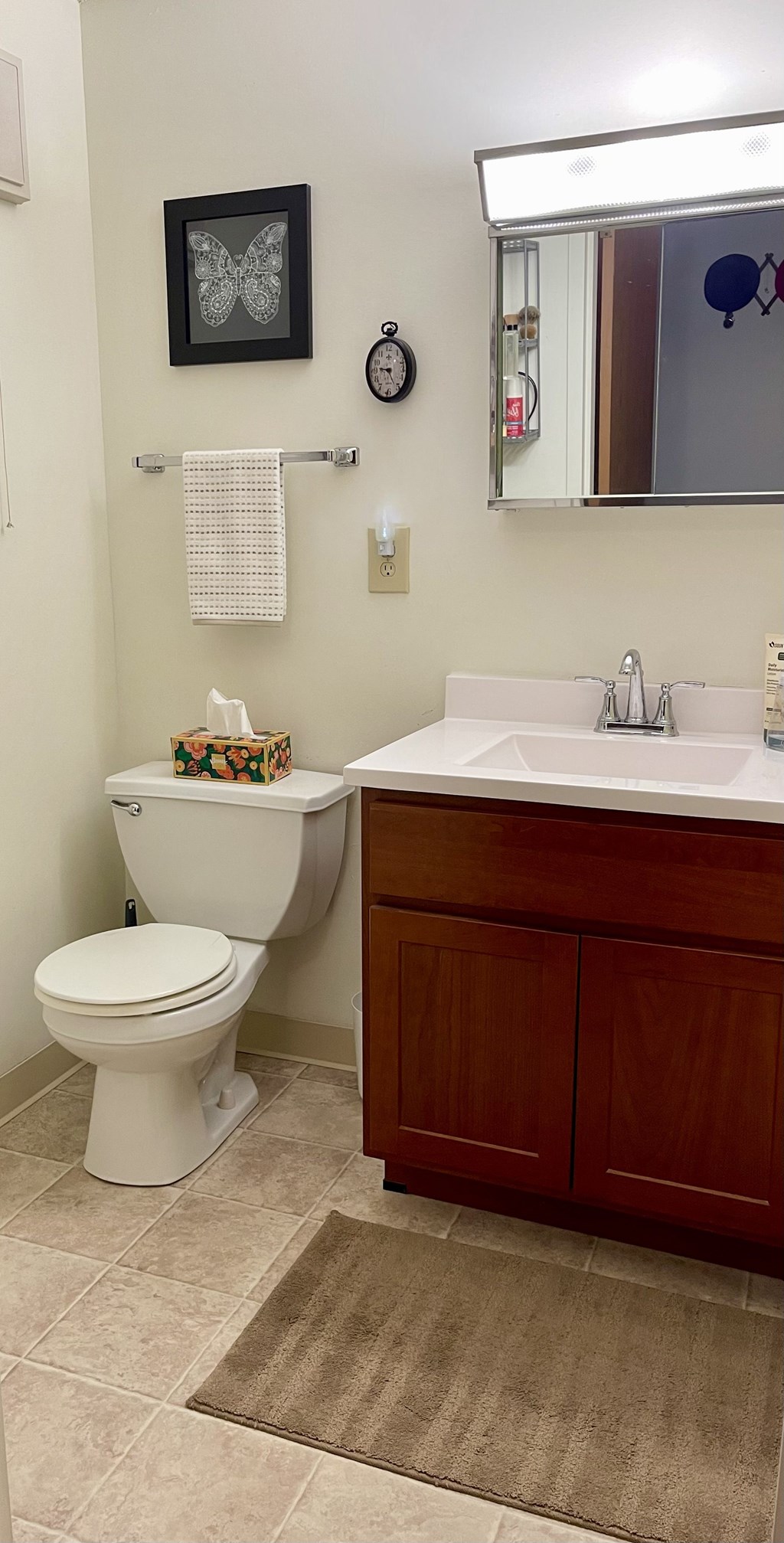 A white toilet sits next to a sink in a bathroom.