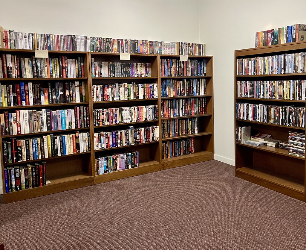 A room filled with bookshelves containing a variety of books.