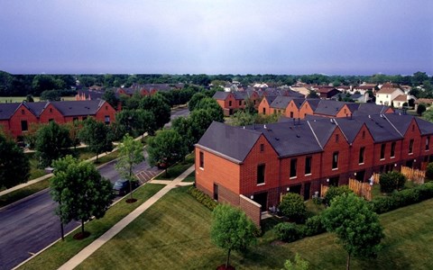 A large housing development with red brick houses.