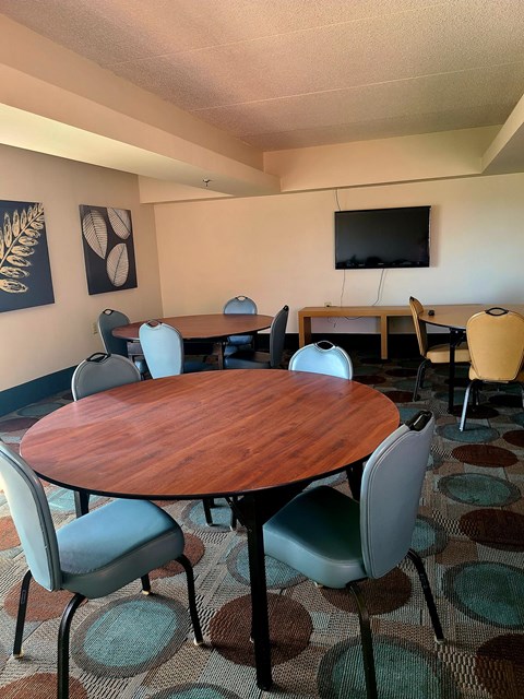 a small conference room with a table and chairs