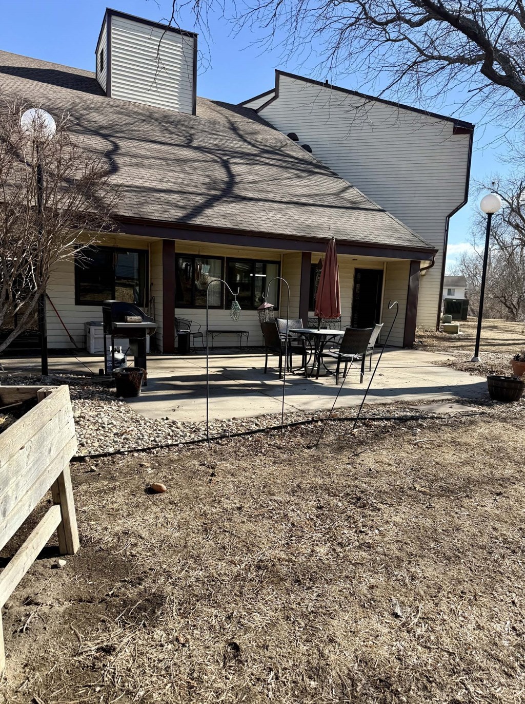 A house with a patio and a table set up outside.