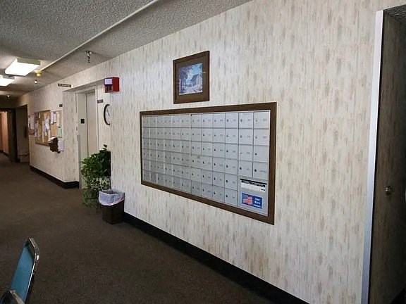 A calendar is on the wall in a room.