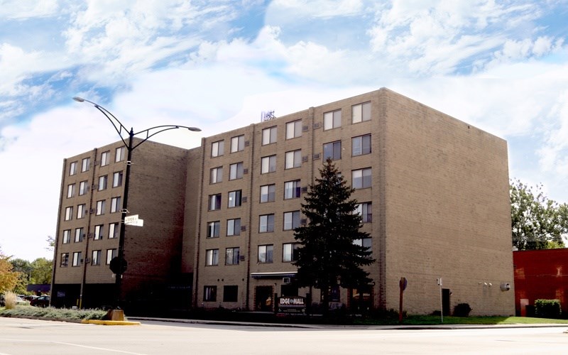 A tall building with a tree in front of it.