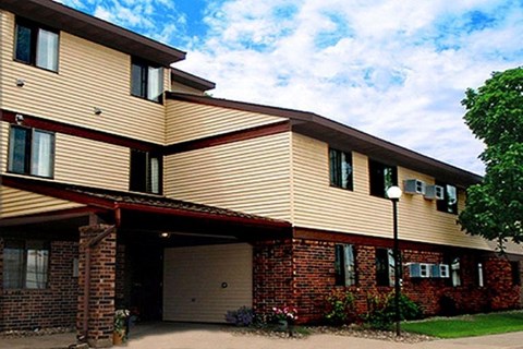 A two-story residential building with a garage door.