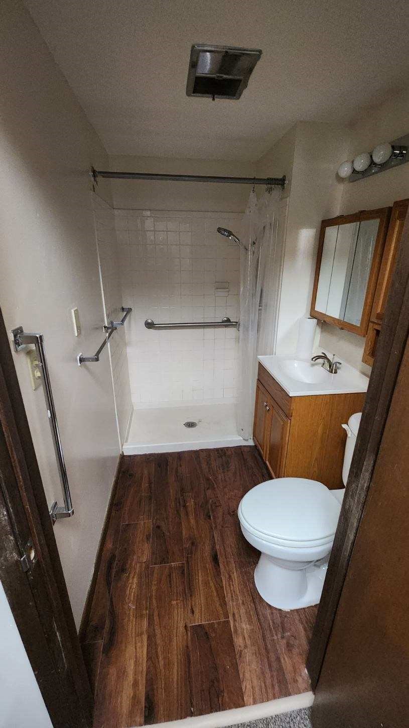 a bathroom with a toilet a sink and a shower