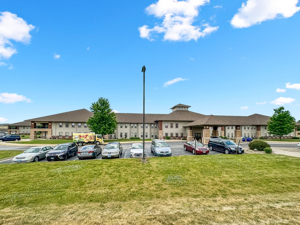 a parking lot with cars in front of a building