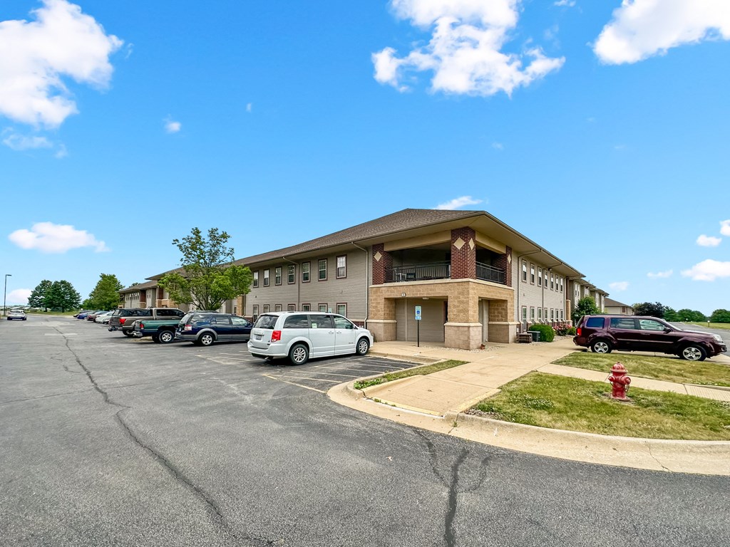 an office building with cars parked in front of it