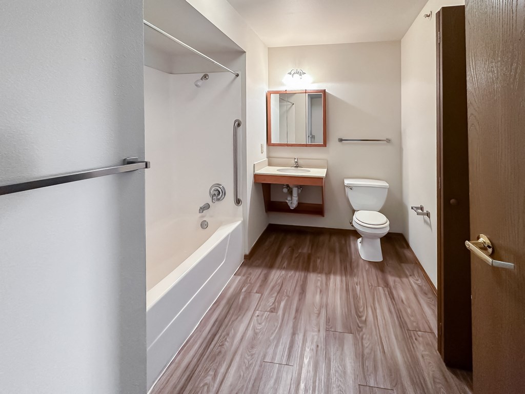 a bathroom with a toilet and a tub and a sink