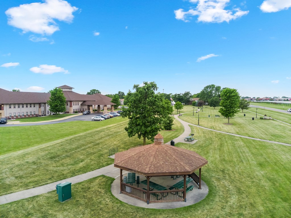 a park with a gazebo and a building in the background