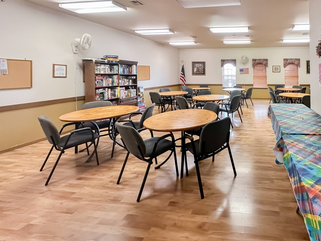 a dining room with tables and chairs and a library