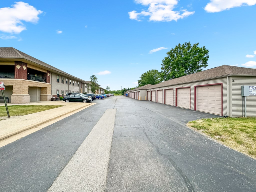 a long street with buildings and cars parked on the side of the road