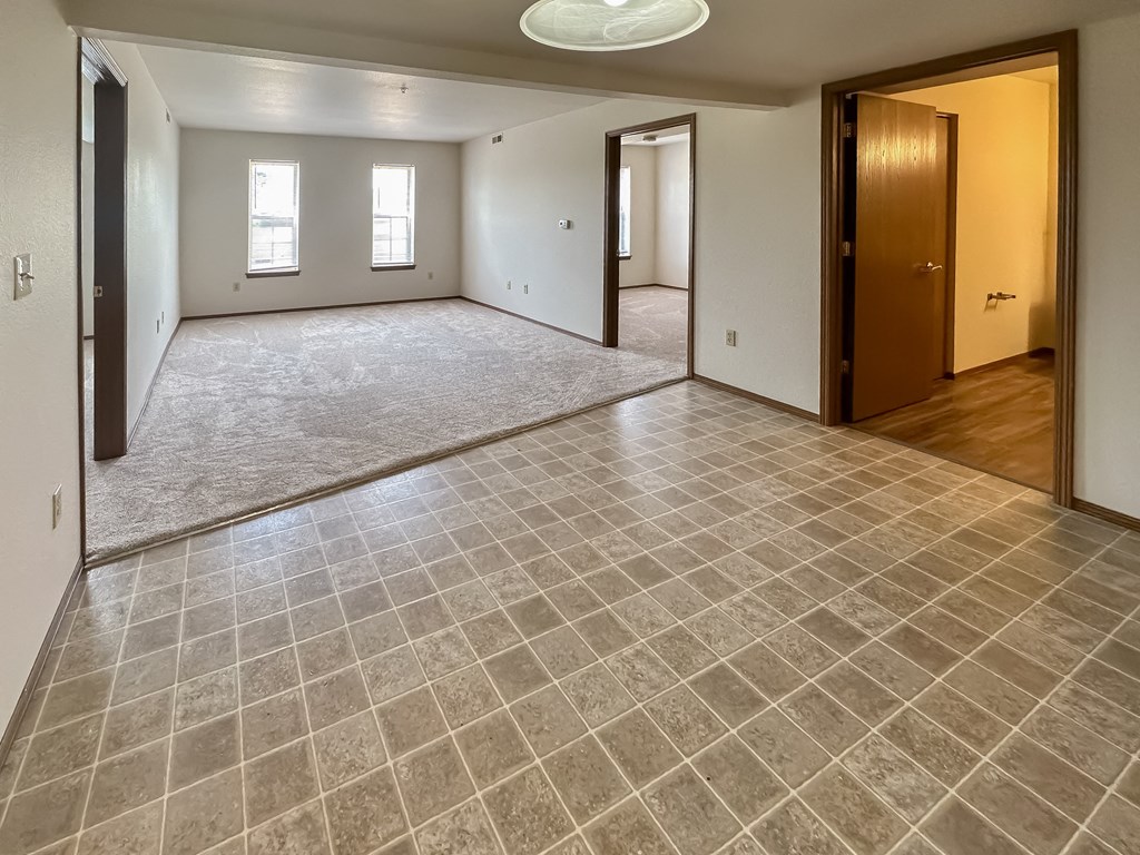 the living room and dining room of a new home with a large empty room