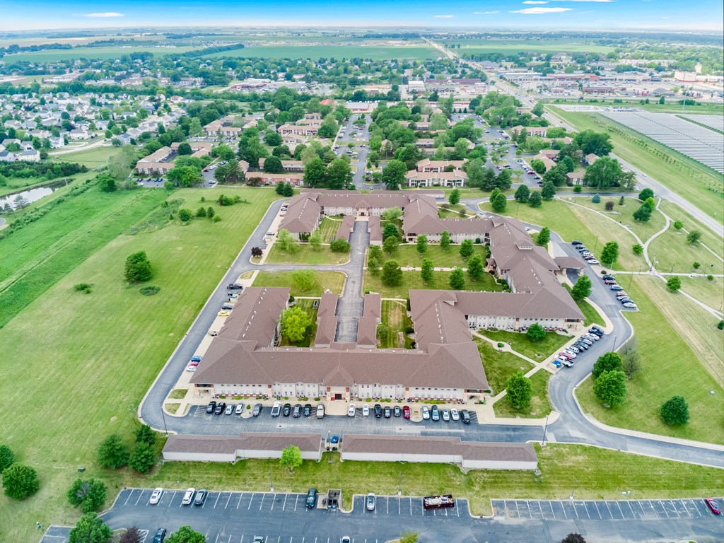 an aerial view of a parking lot and a large building in a parking