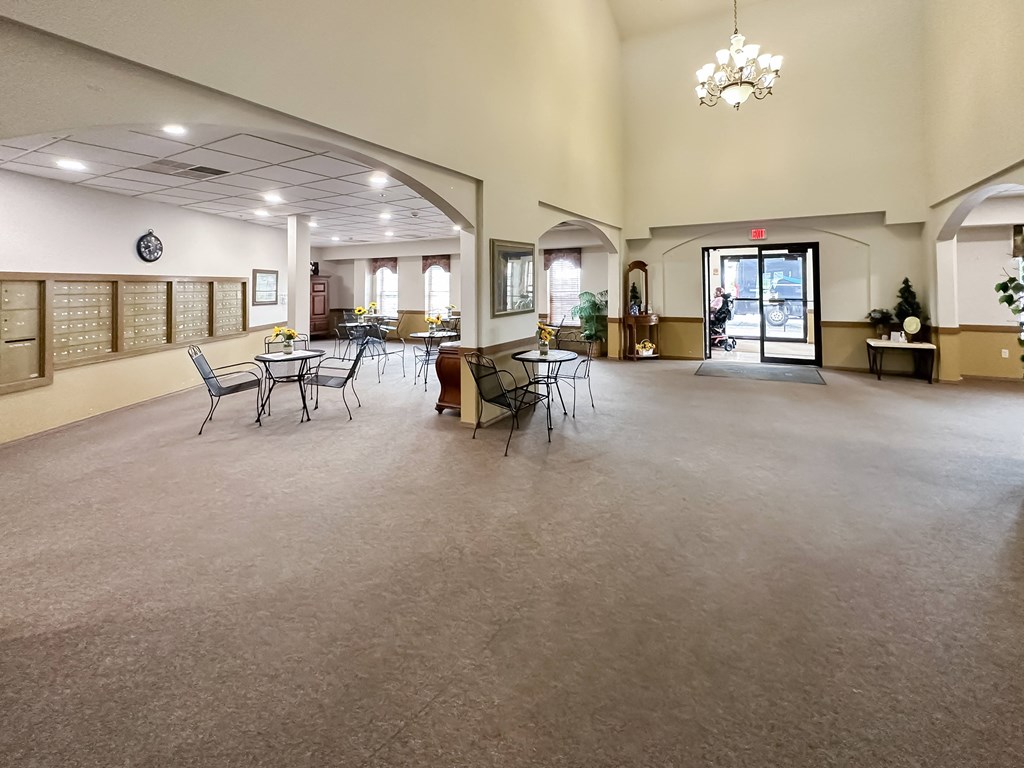 a large room with tables and chairs in the center of it