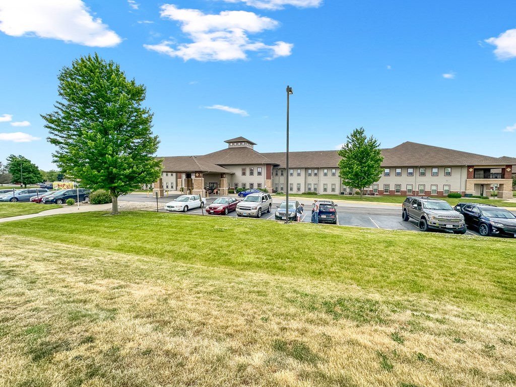 a parking lot with cars in front of a building