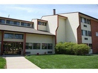 a large building with a lawn in front of it