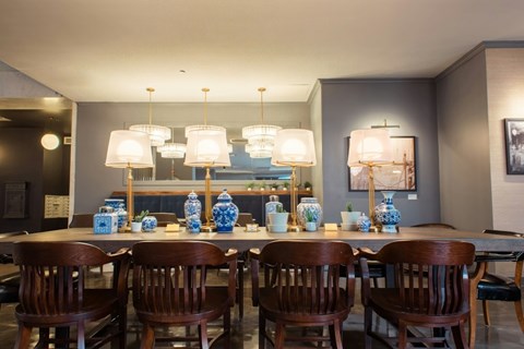 A dining room with a table set for six.
