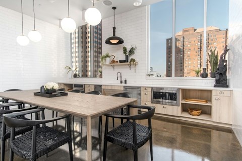 A modern kitchen with a dining table and chairs.